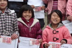 Overjoyed children holding award and certificate